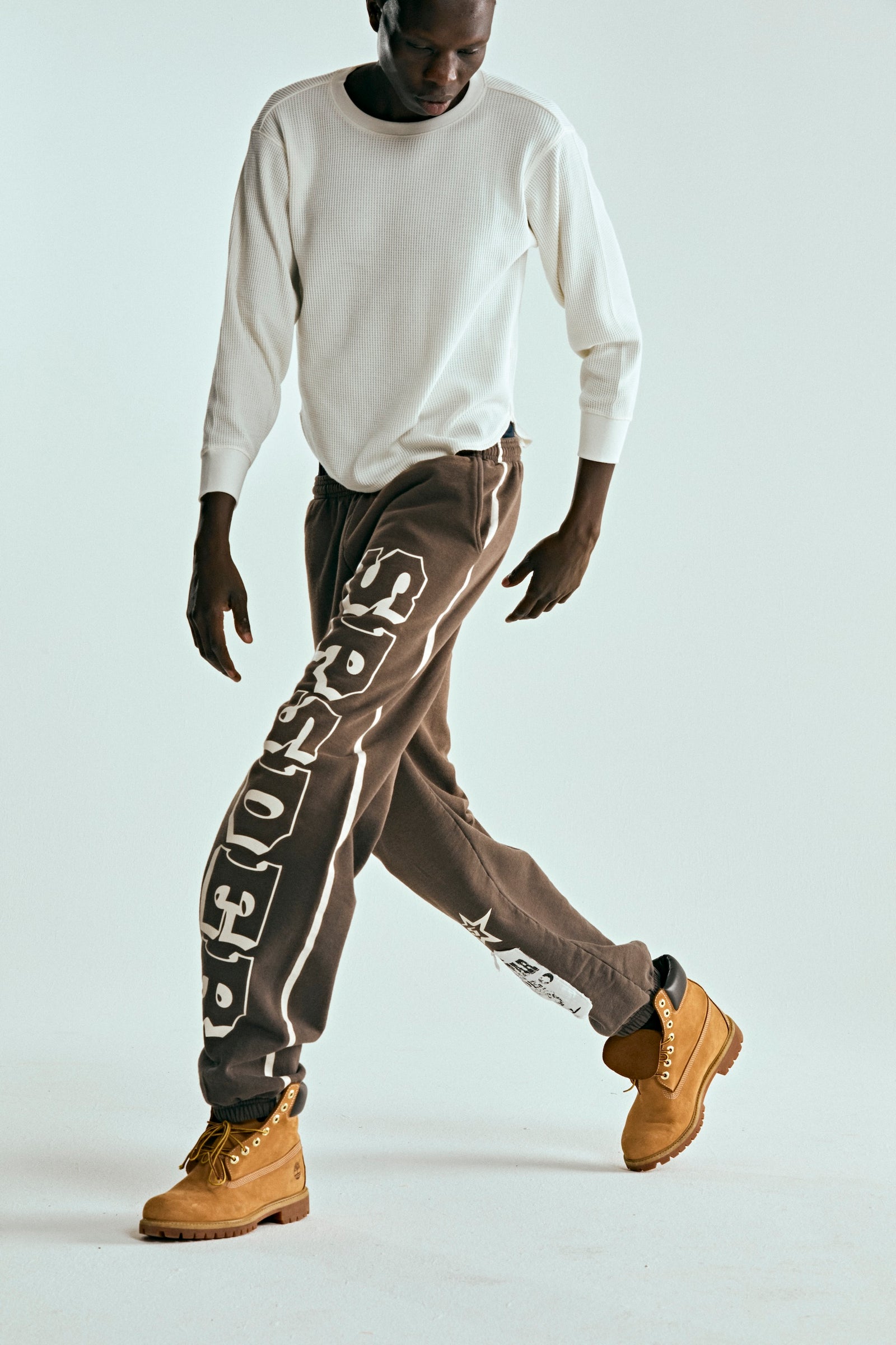 Brown 5STAR RODEO SWEATPANT with white SP5DER text print, side stripe, and distressed patch.