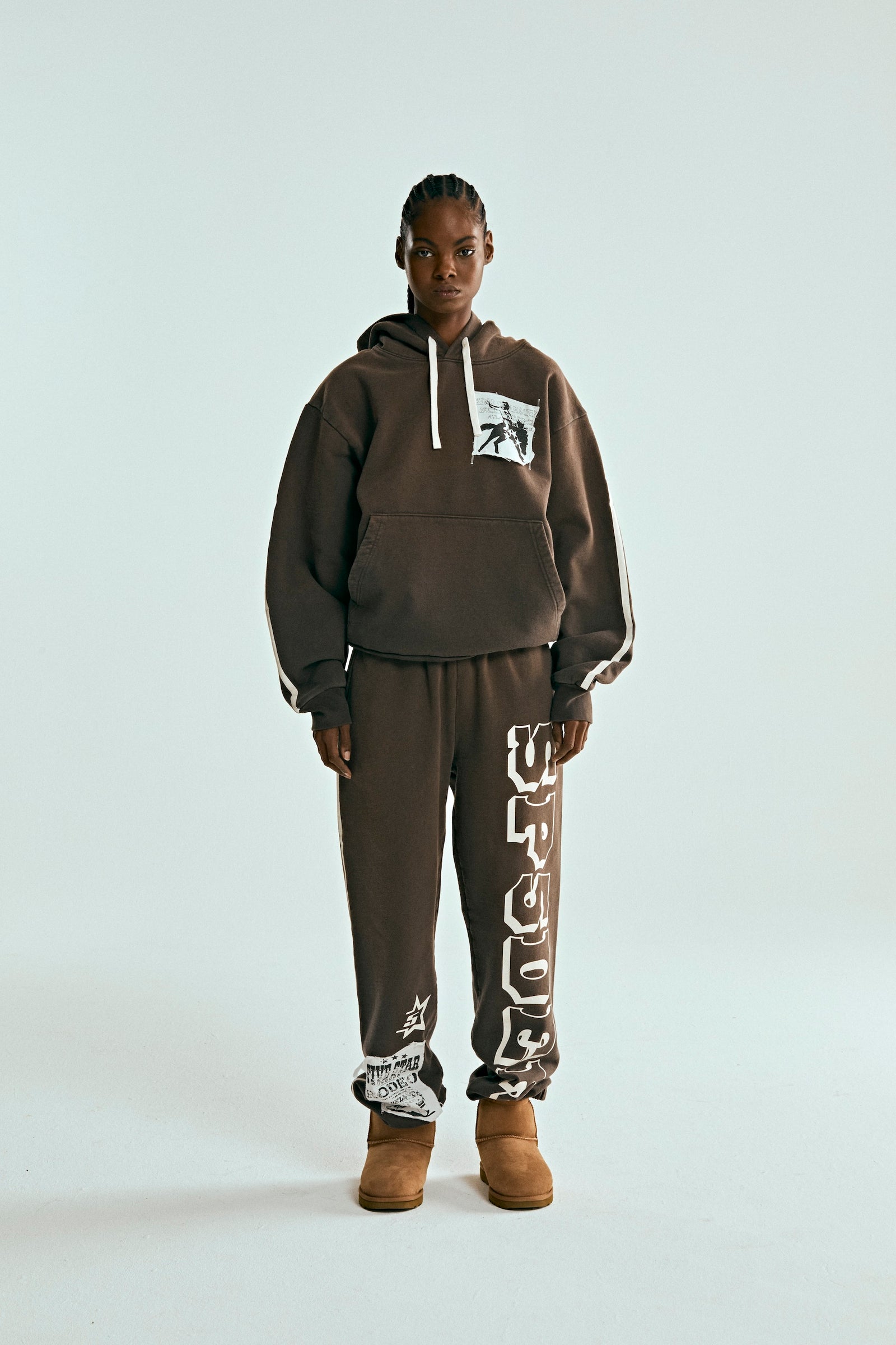 Brown 5STAR Rodeo hoodie and sweatpants set with distressed chest patch, drawstring, and white side stripes.