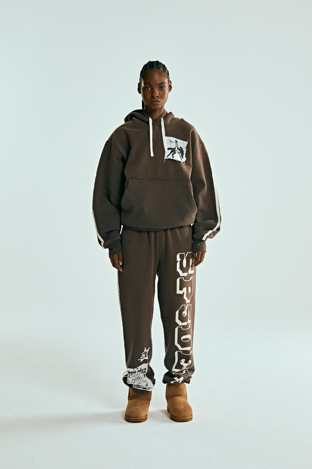 Brown 5STAR Rodeo hoodie and sweatpants set with distressed chest patch, drawstring, and white side stripes.