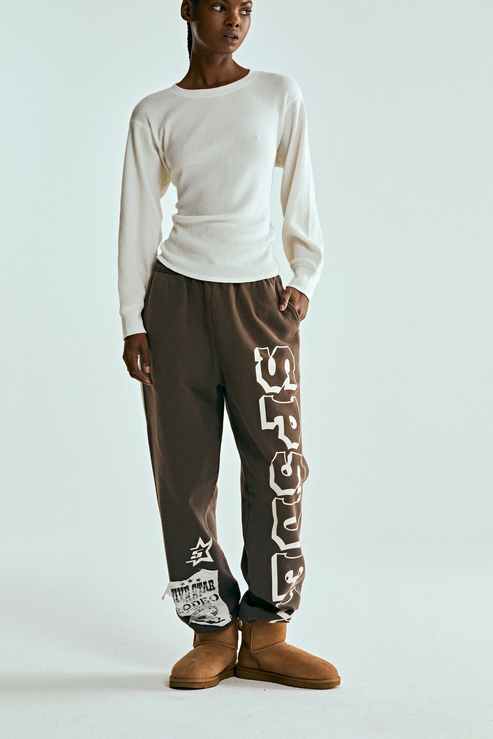 Brown 5STAR RODEO SWEATPANT with white SP5DER text, distressed patch, and side stripe.