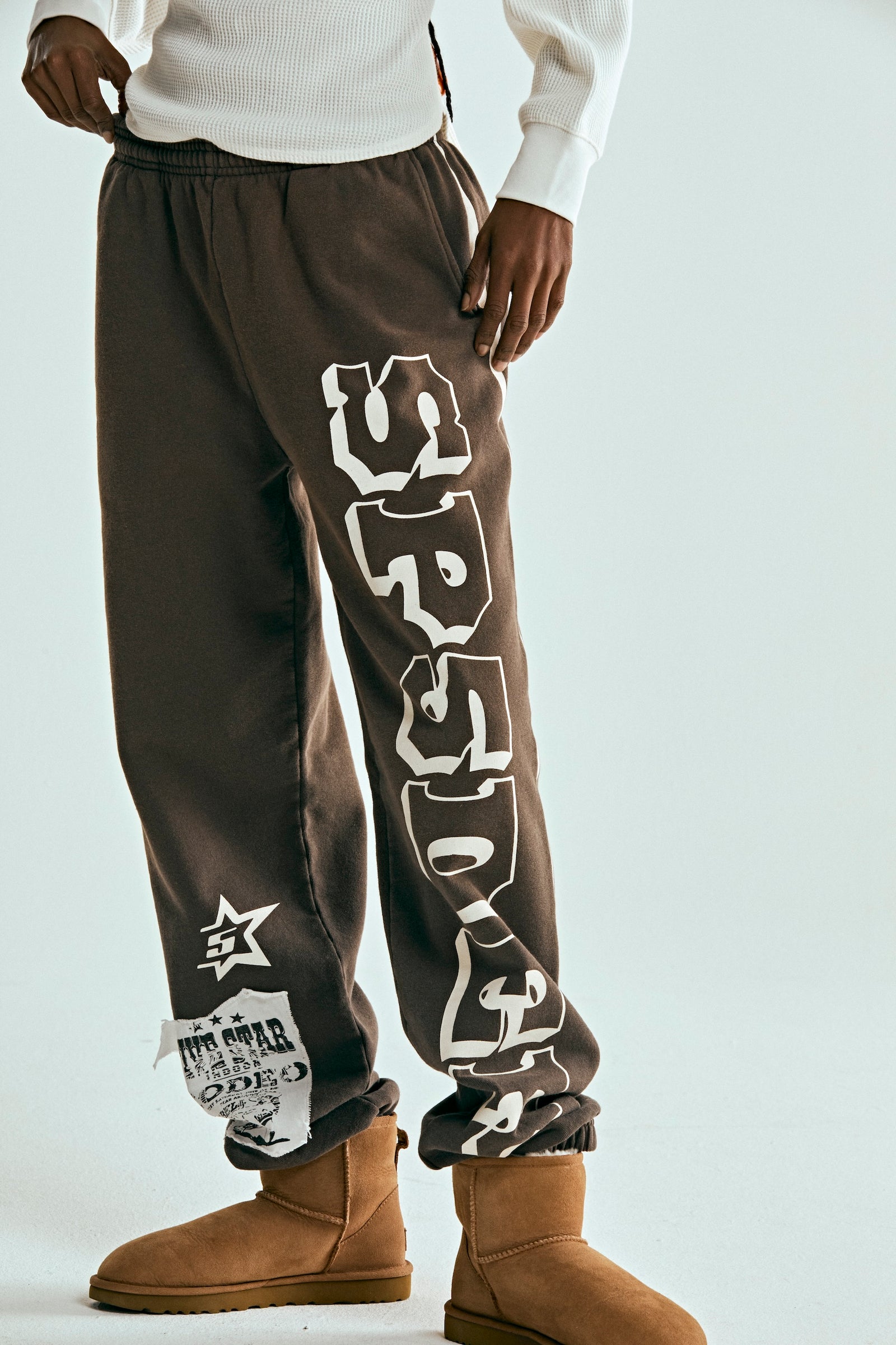 Brown 5STAR RODEO SWEATPANT with white SP5DER text, side stripe, and distressed patch.