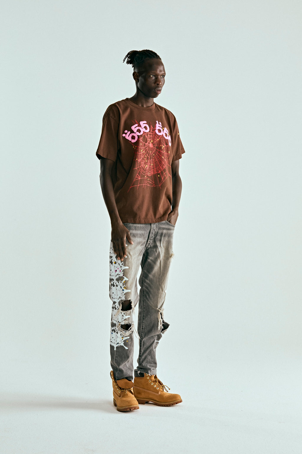 Brown 100% cotton ANGEL NUMBER TEE with pink '555' puff print and web graphic, worn by a model.