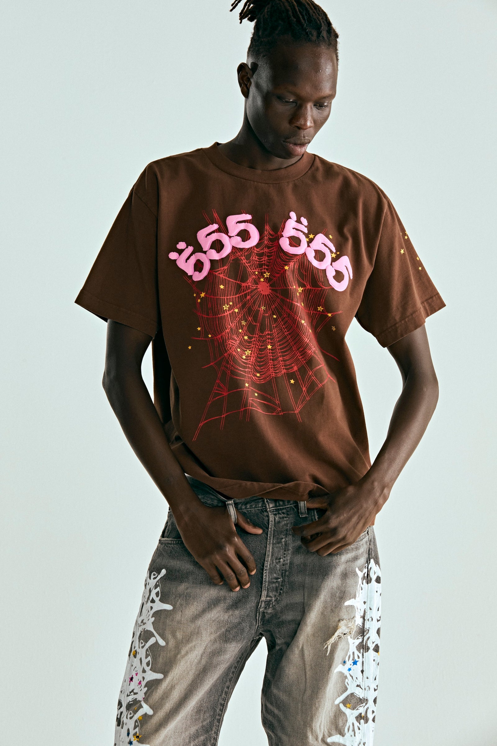 Brown 100% cotton tee with pink puff print '555' angel numbers and red spider web graphic.