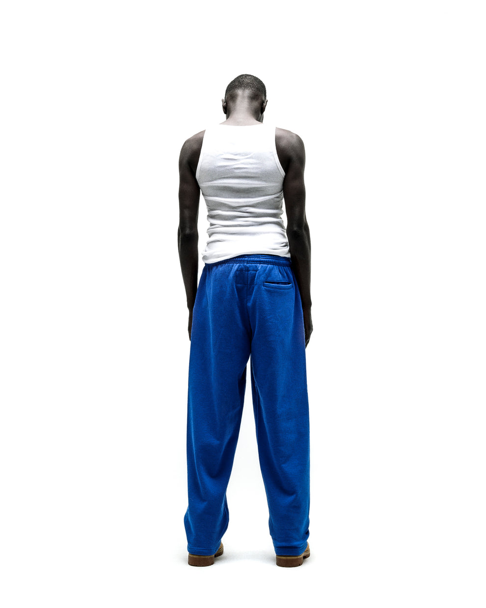 Model wearing blue RHINESTONE PUNK V2 SWEATPANT with wide leg silhouette and elasticized waistband.