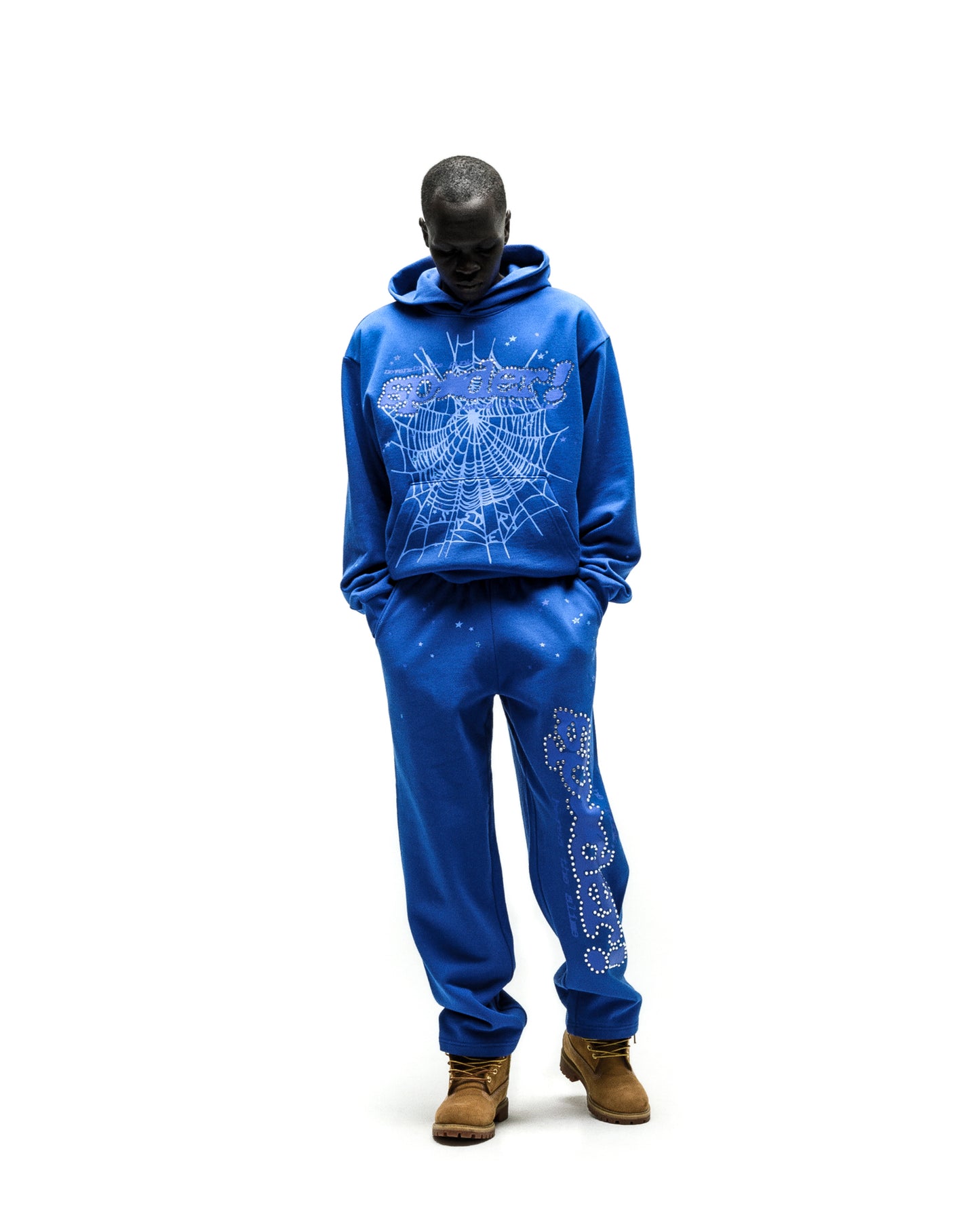 Blue RHINESTONE PUNK V2 hoodie and sweatpants with SP5DER motif and web design.