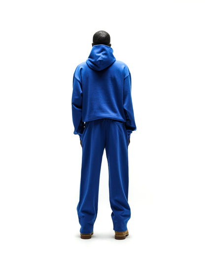 Back view of a person wearing a blue RHINESTONE PUNK V2 HOODIE and matching sweatpants.