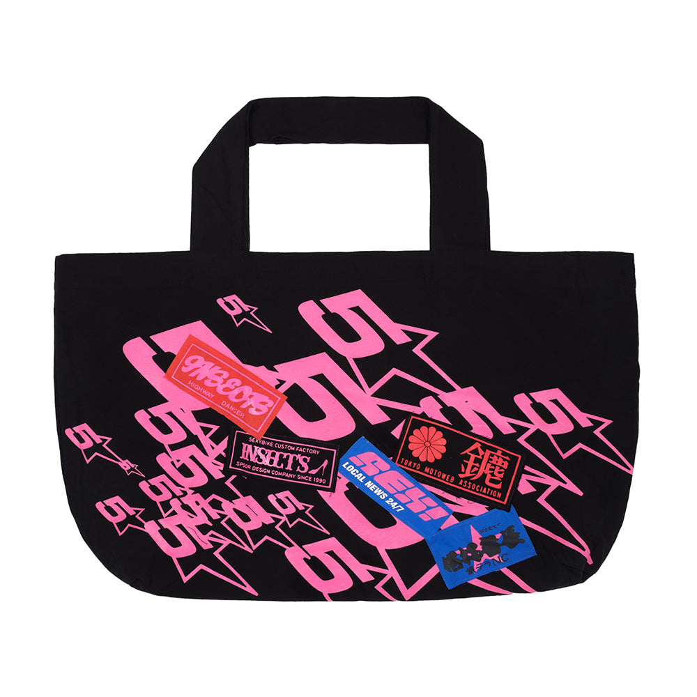 Black oversized twill tote bag with jumbo pink graphic print and colorful custom patches.