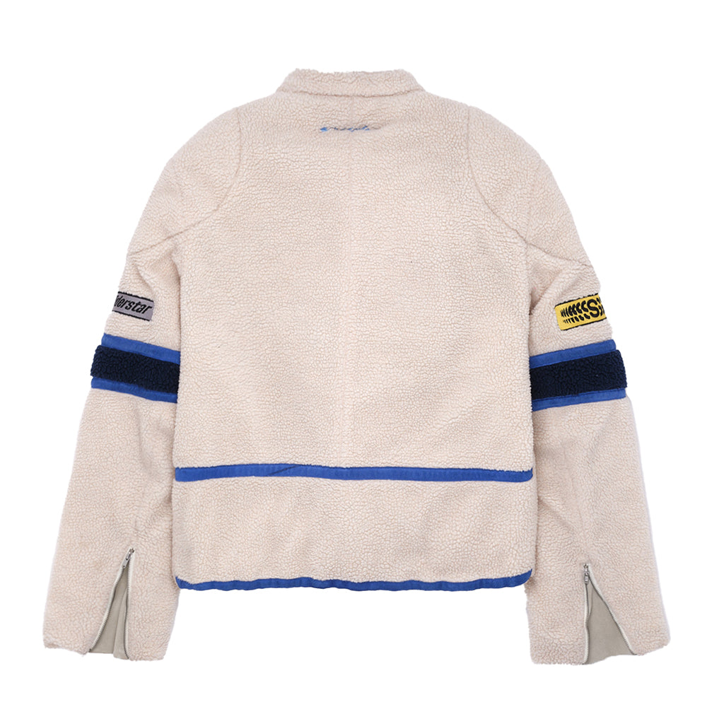 Cream sherpa cafe racer jacket with blue and black stripes, leather trim, and SP5DER patches.