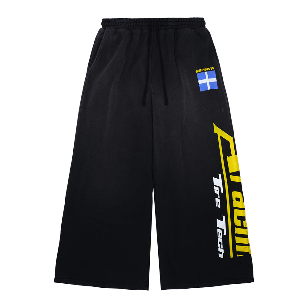 JUMBO SWEATPANT: Vintage black 23oz French terry sweatpants with yellow "Tire Tech" screen print and blue flag patch.