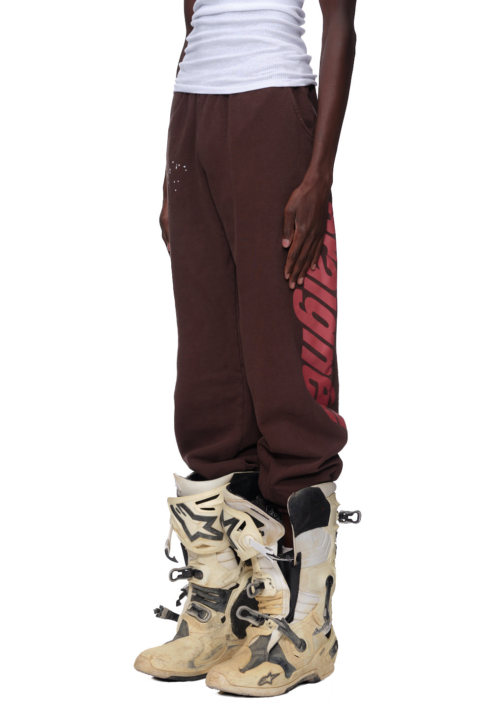 Brown fleece sweatpants with red 'Araignee' print down the leg and white puff print details.