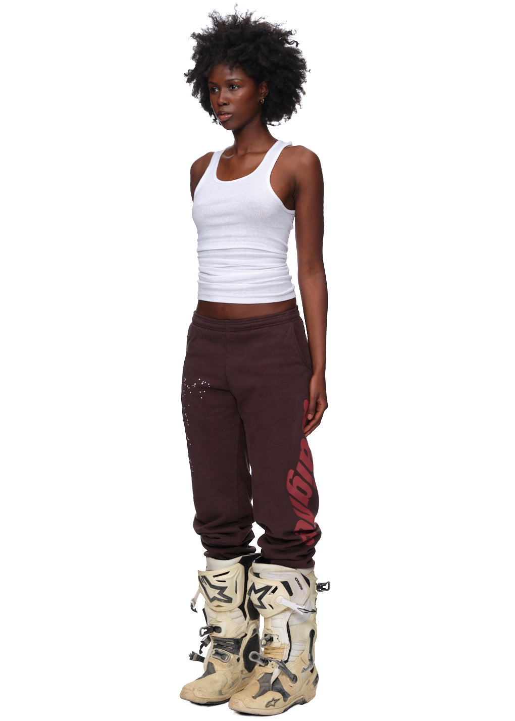Model wearing brown Araignee sweatpants with red puff print, made from 23oz USA-milled fleece.