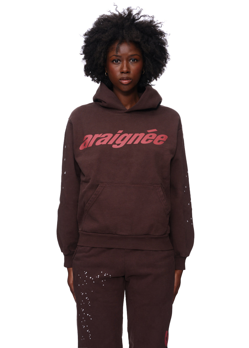 Brown Araignée hoodie with red puff print logo, worn by a model.