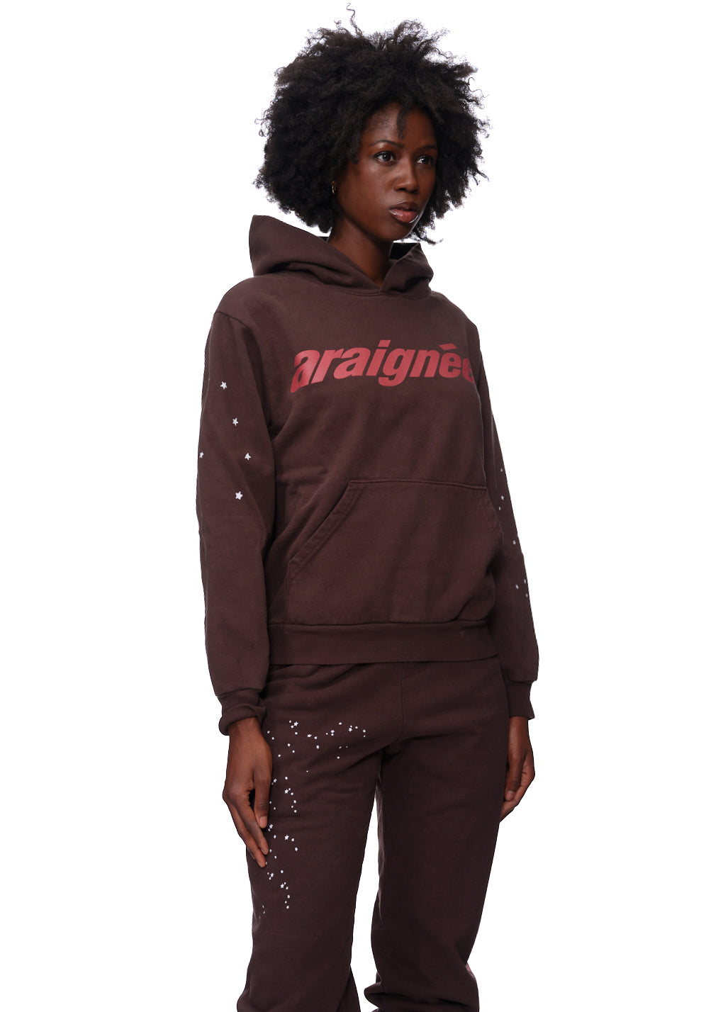 Brown 23oz fleece hoodie with red 'araignée' puff print and white star details on sleeves.