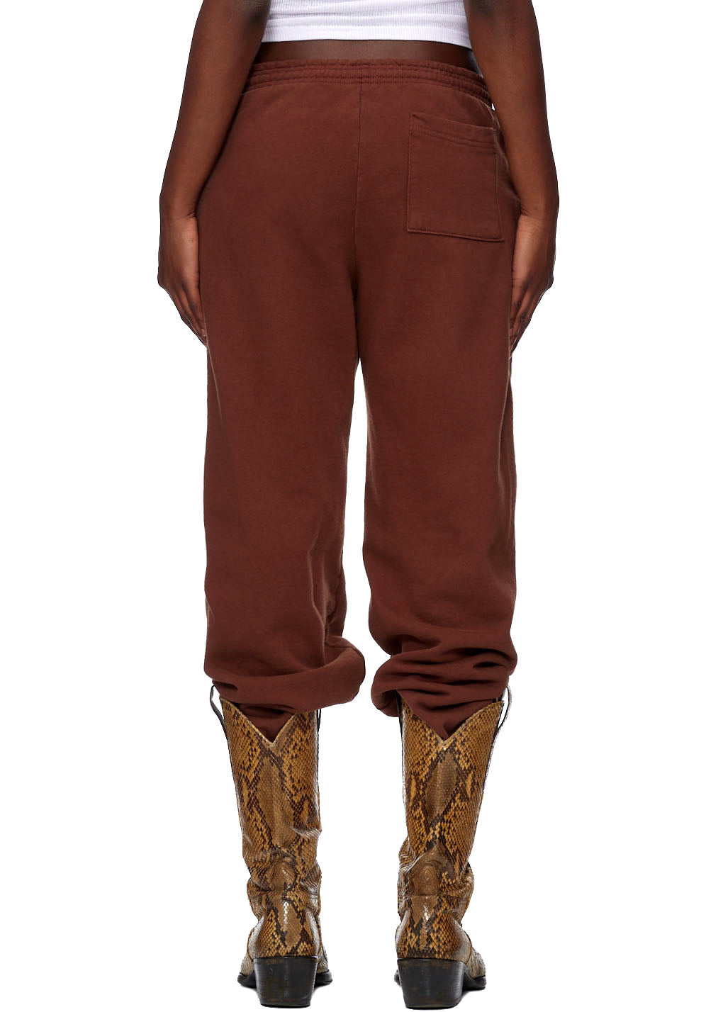 Brown CLASSIC SWEATPANT, 23oz fleece, with SP5DER web print, worn with snakeskin boots.