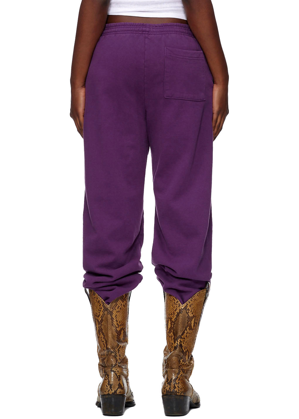Purple CLASSIC SWEATPANT with SP5DER web print, 23oz fleece, worn with snakeskin cowboy boots.