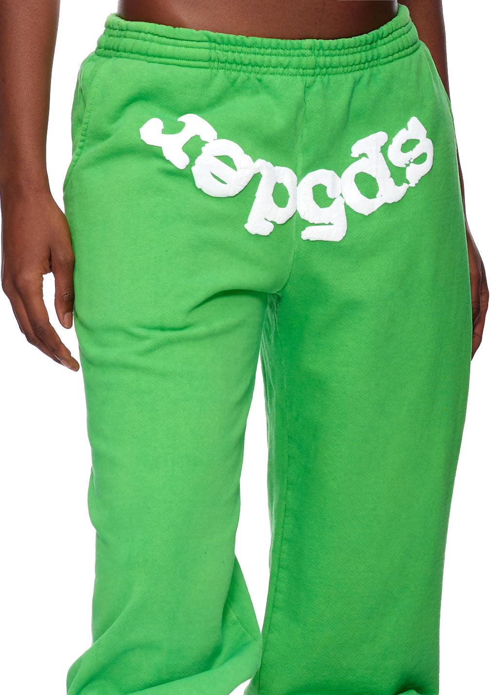Green fleece sweatpants with white puff print "sp5der" logo across the front waistband.
