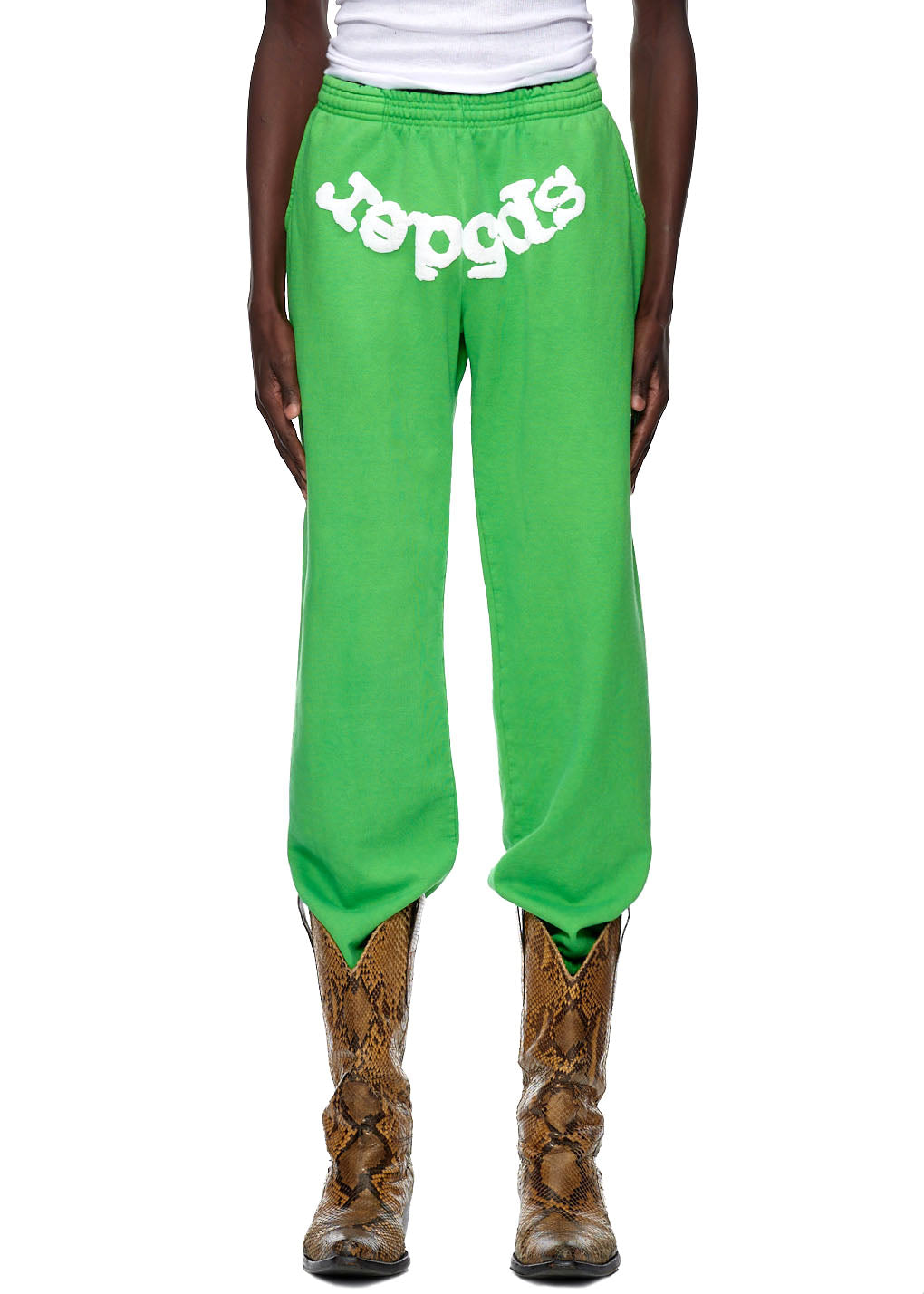 Green CLASSIC SWEATPANT with white "SP5DER" puff print, worn with brown snakeskin boots.