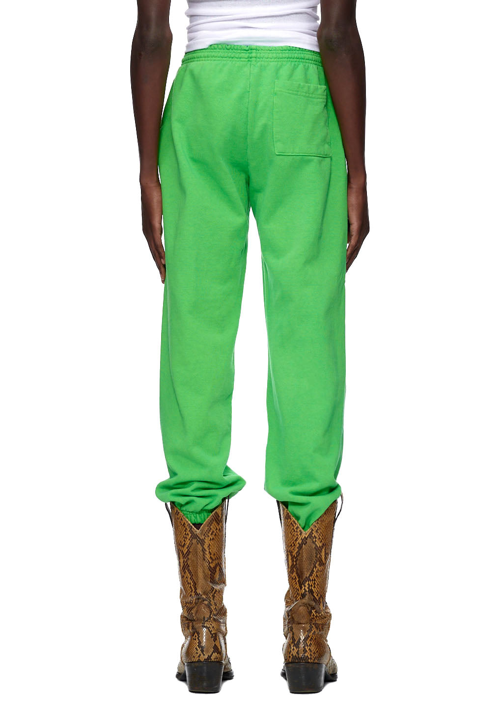 Classic green fleece sweatpants with elastic waist and cuffs, worn with brown snakeskin boots.