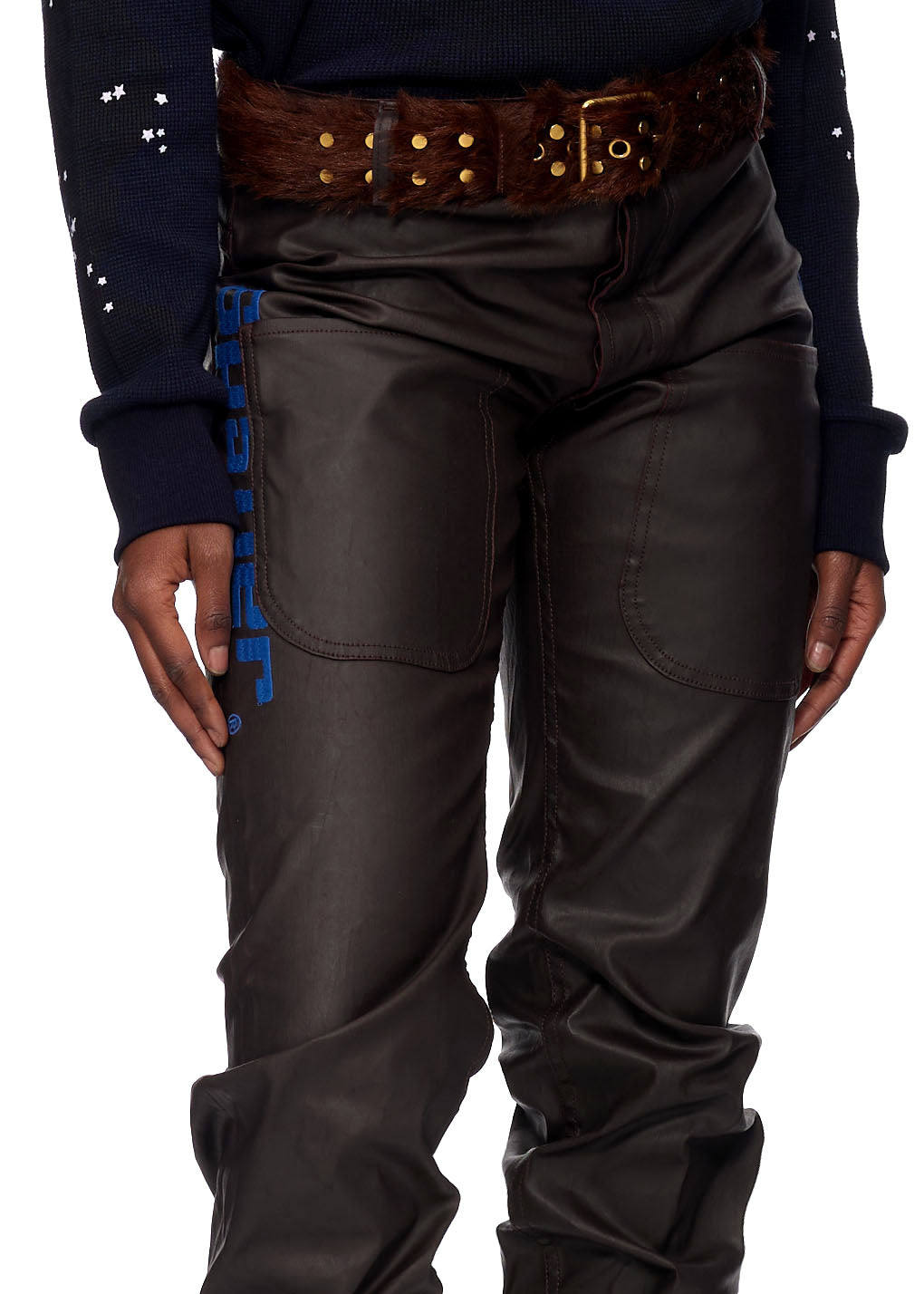 Brown coated canvas front pocket jeans with blue SP5DER branding and a fur belt.