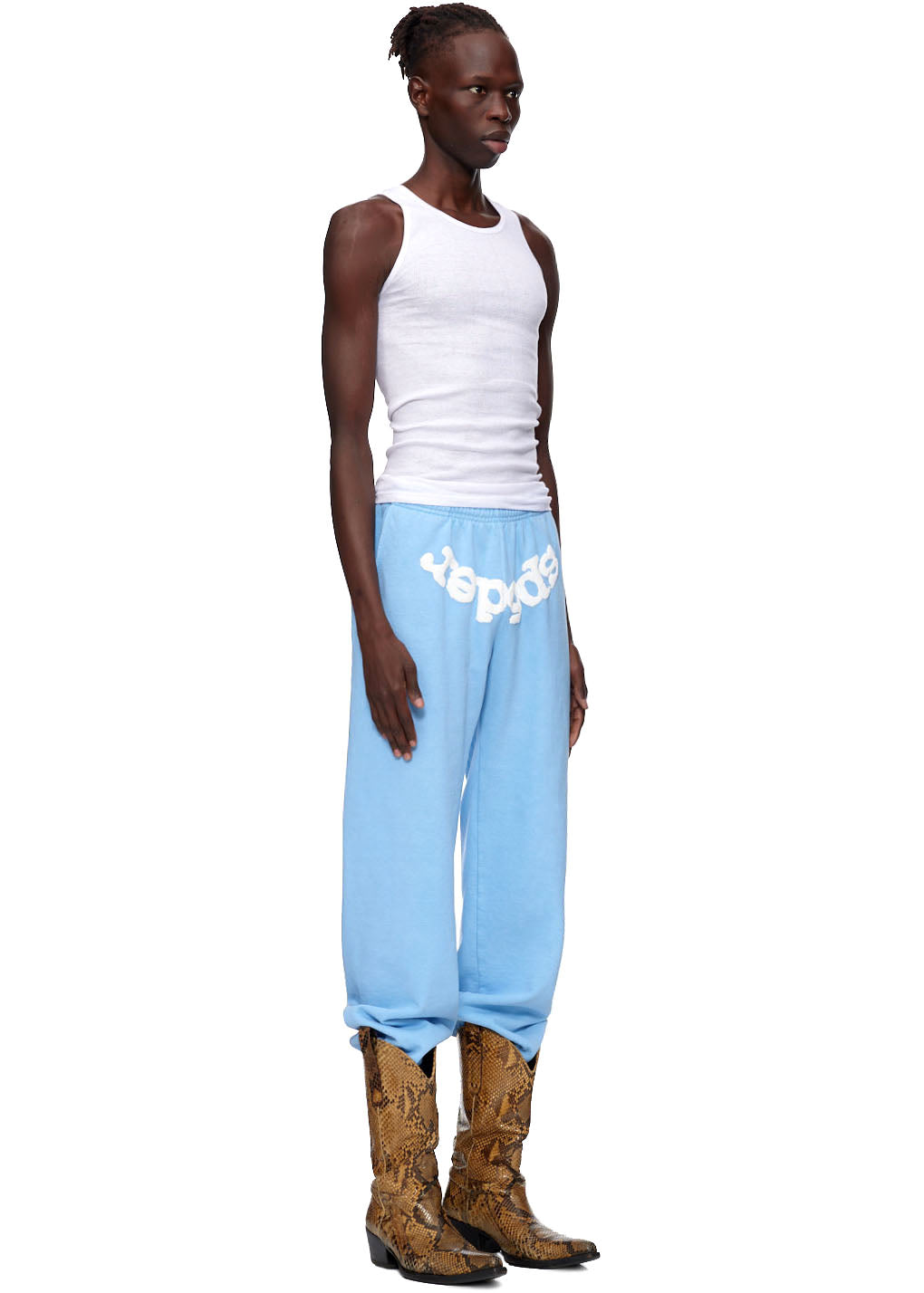 Light blue CLASSIC SWEATPANT with white "spider" puff print, worn by a model in a white tank top and snakeskin boots.