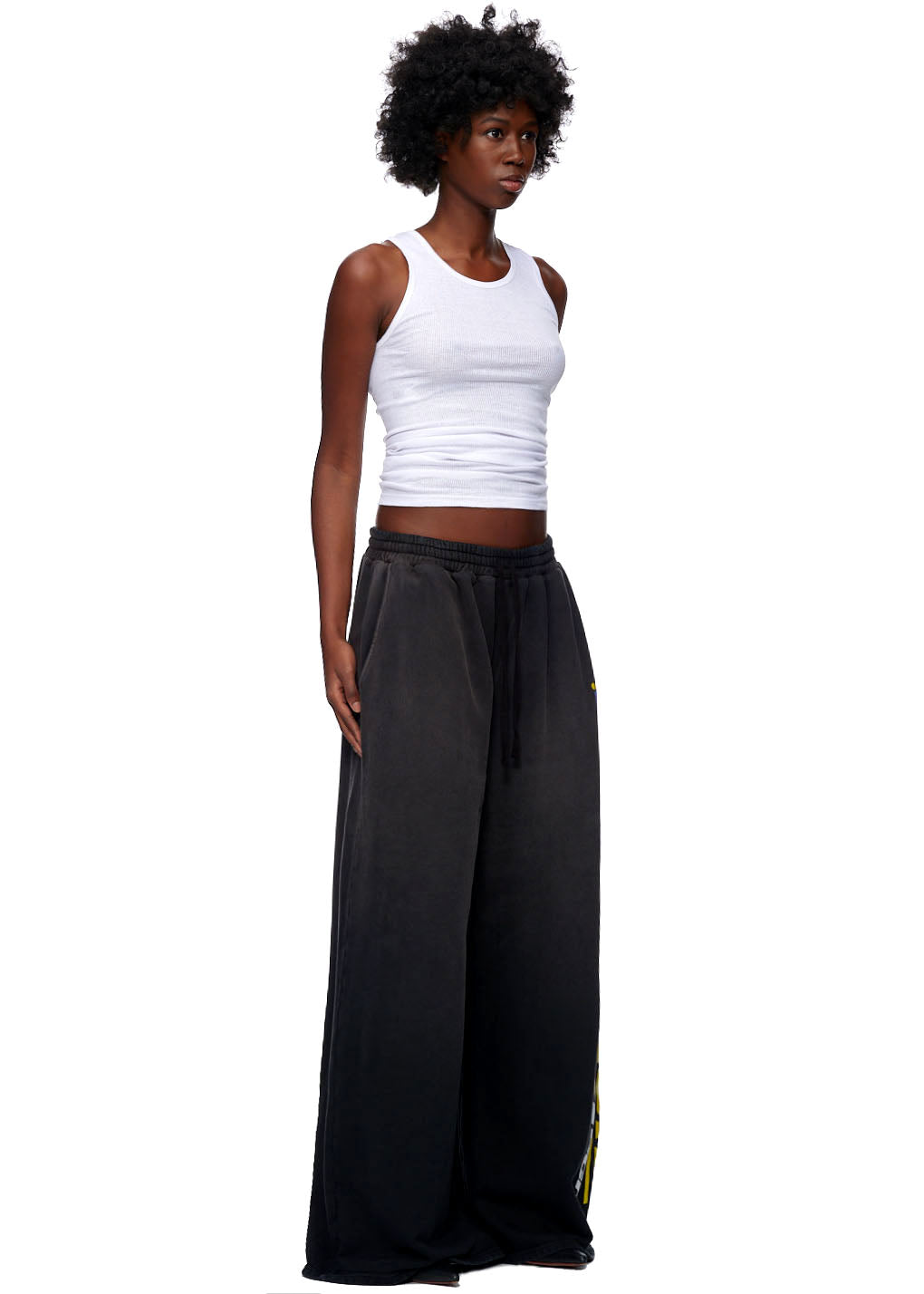 Jumbo vintage black French terry sweatpants with yellow screen print down the leg.