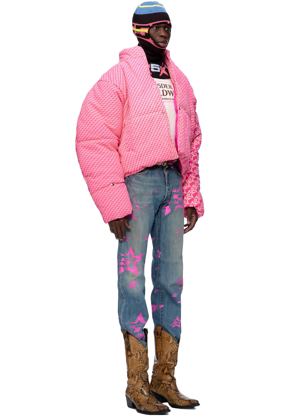 Pink puffer jacket with all-over "5 Star" print, worn with blue jeans and cowboy boots.