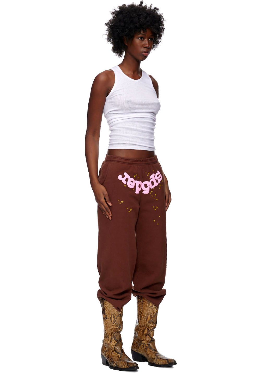 Brown fleece sweatpants with pink "SP5DER" puff print and gold star discharge print.
