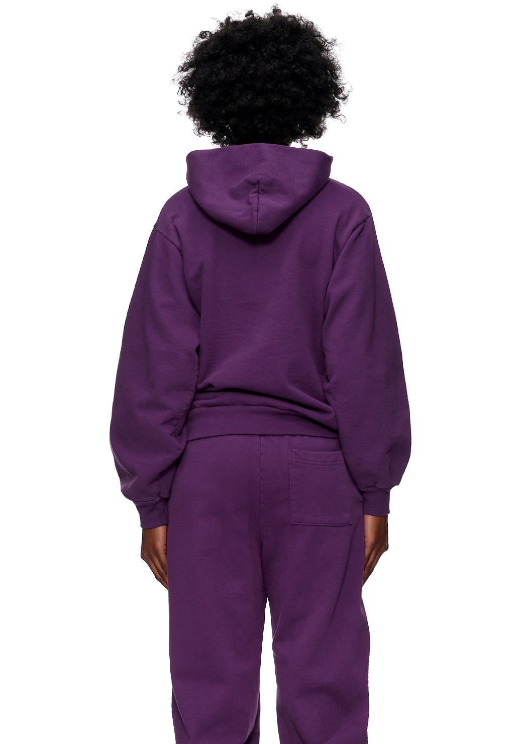 Back of a person wearing a dark purple SP5DER WEB HOODIE and matching sweatpants.