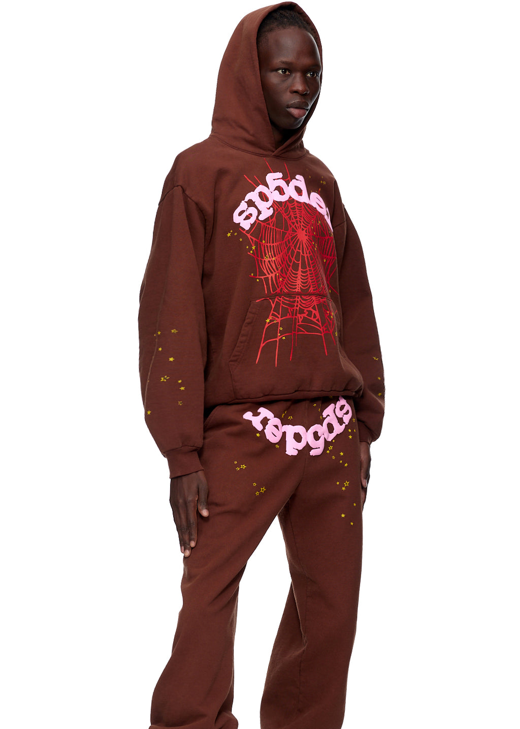 Brown fleece hoodie and sweatpants with pink "sp5der" text and red spider web print.