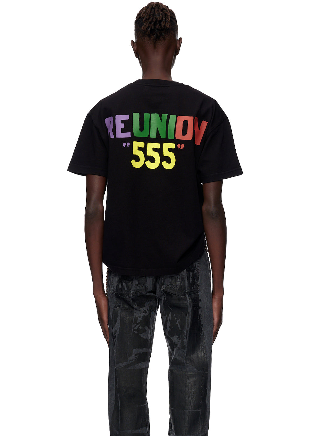 Black oversized cotton jersey tee with "REUNION" in colorful block letters and "555" in yellow on the back.