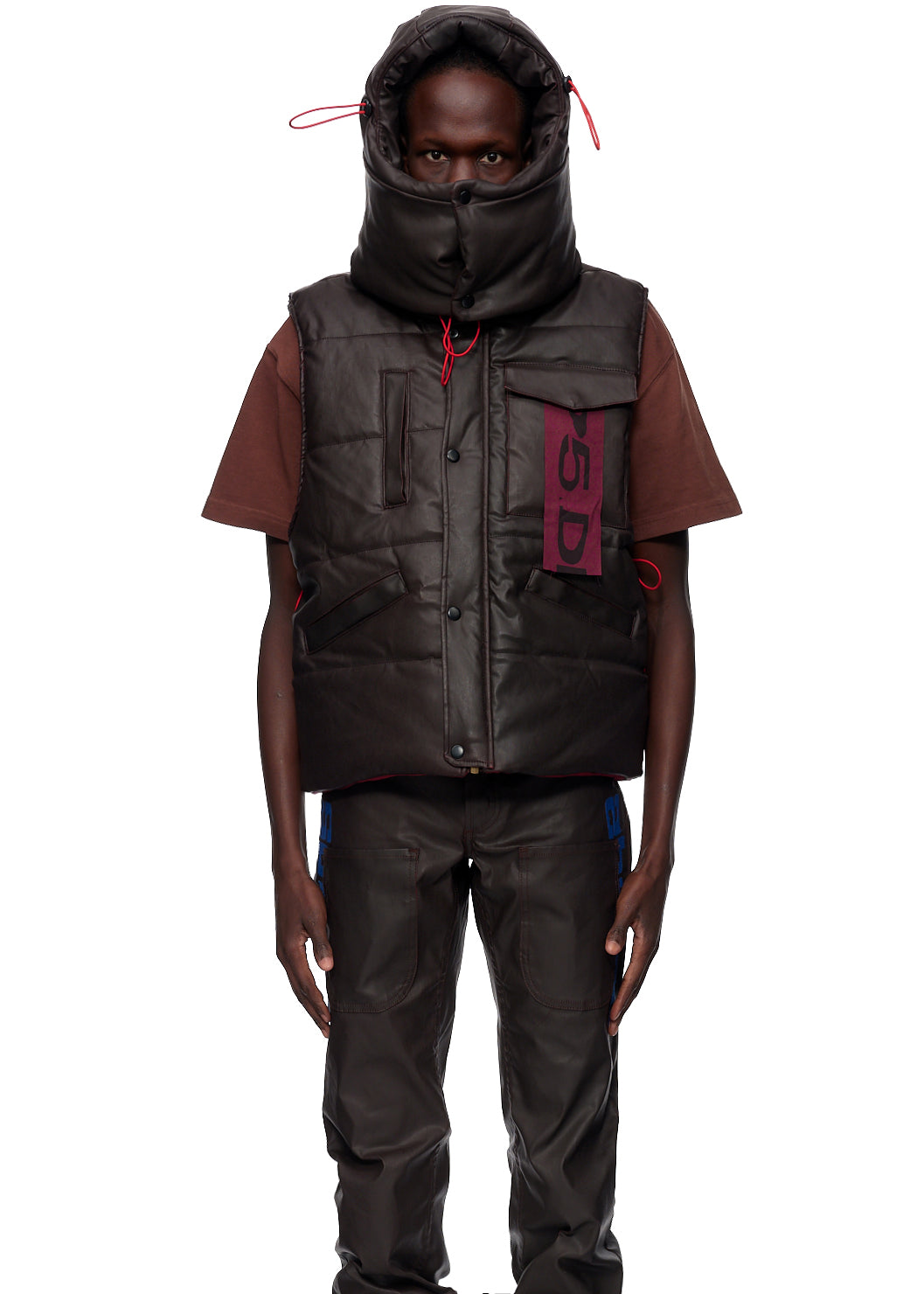 Brown coated canvas hooded puffer vest with antique brass zipper and branded SP5DER label.
