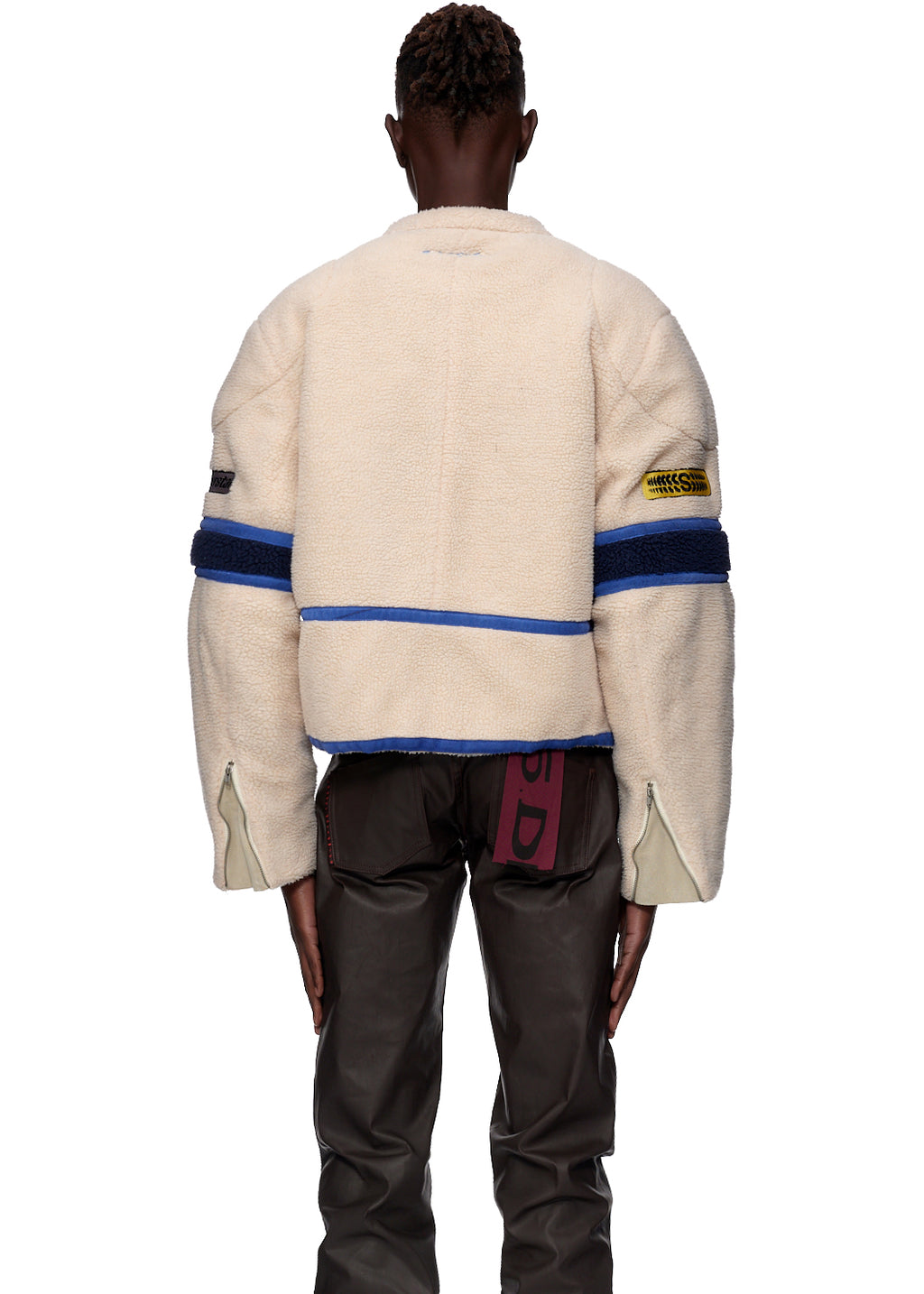 Sherpa Cafe Racer jacket, cream polyester with blue stripes, leather trim, and SP5DER patches.