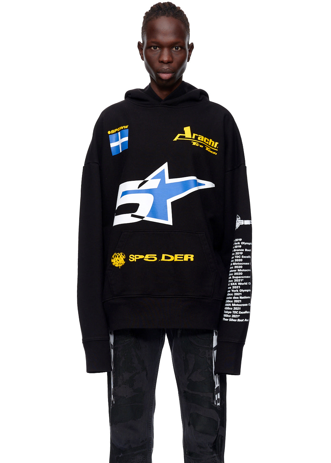 Black oversized 23oz French Terry hoodie with blue and yellow racing graphics, worn by a model.