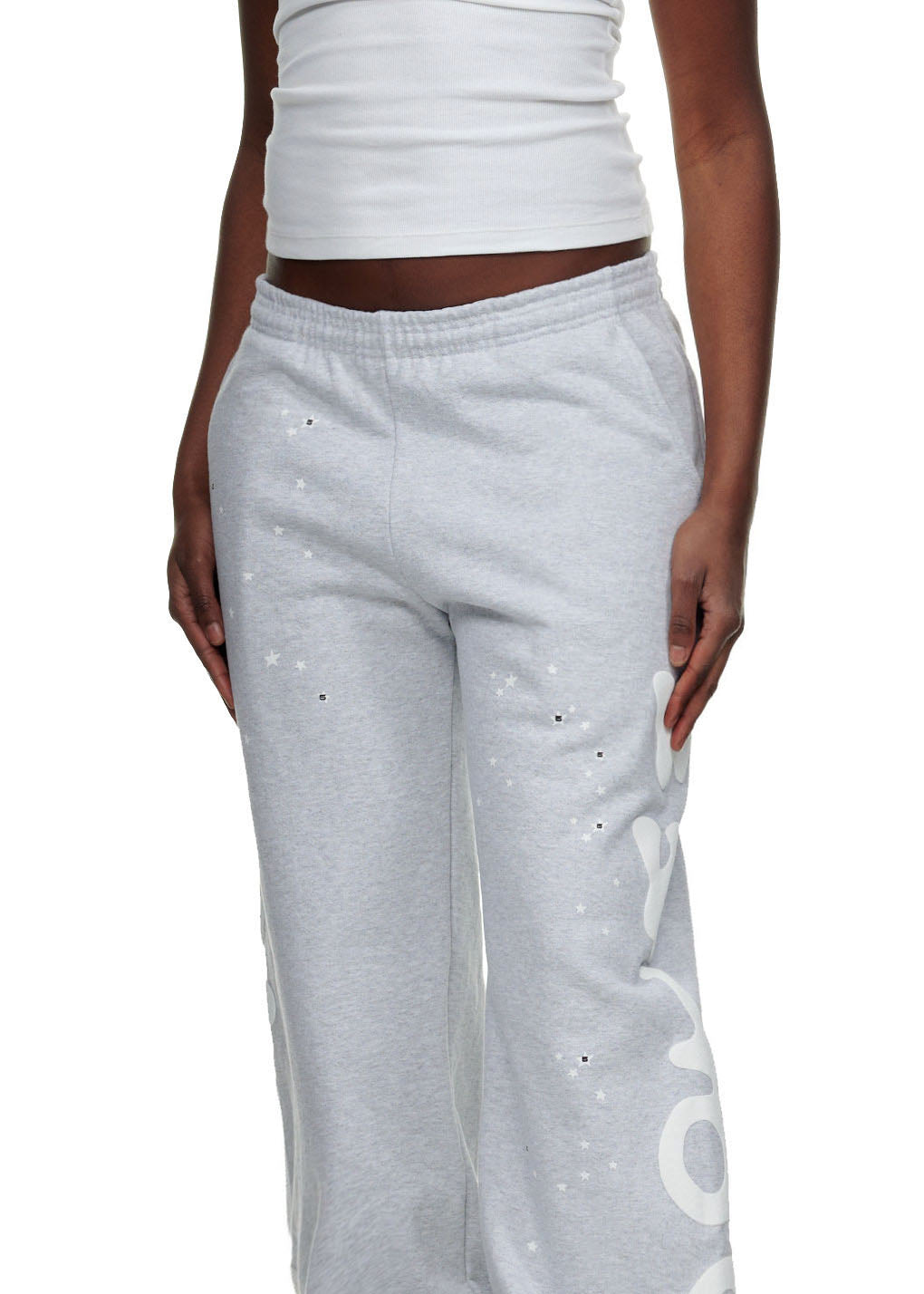 Light gray fleece sweatpants with white puff print "Worldwide" text and star details.