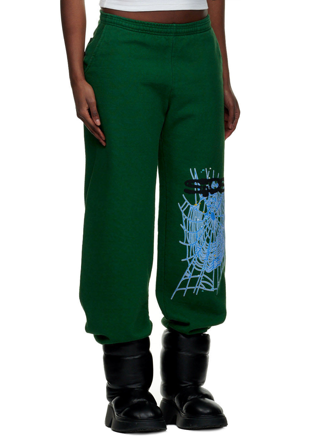 Green 23oz fleece sweatpants with blue SP5DER text and web print on the left leg.