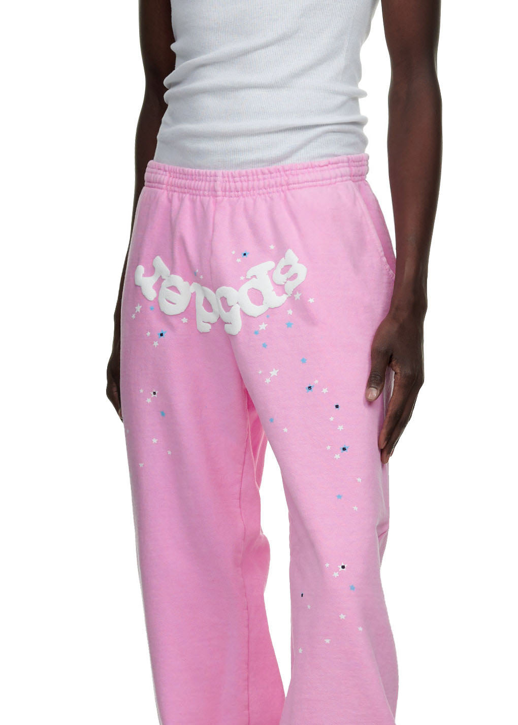 Pink fleece sweatpants with "Sp5der" puff print and scattered star graphics.