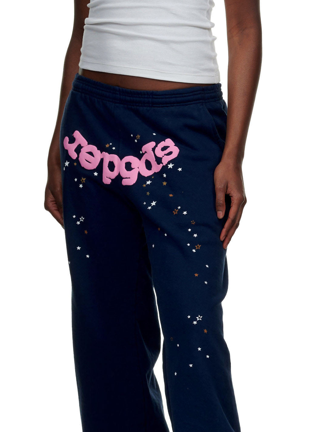 Navy fleece sweatpants with pink puff print "Sp5der" and scattered star graphics.