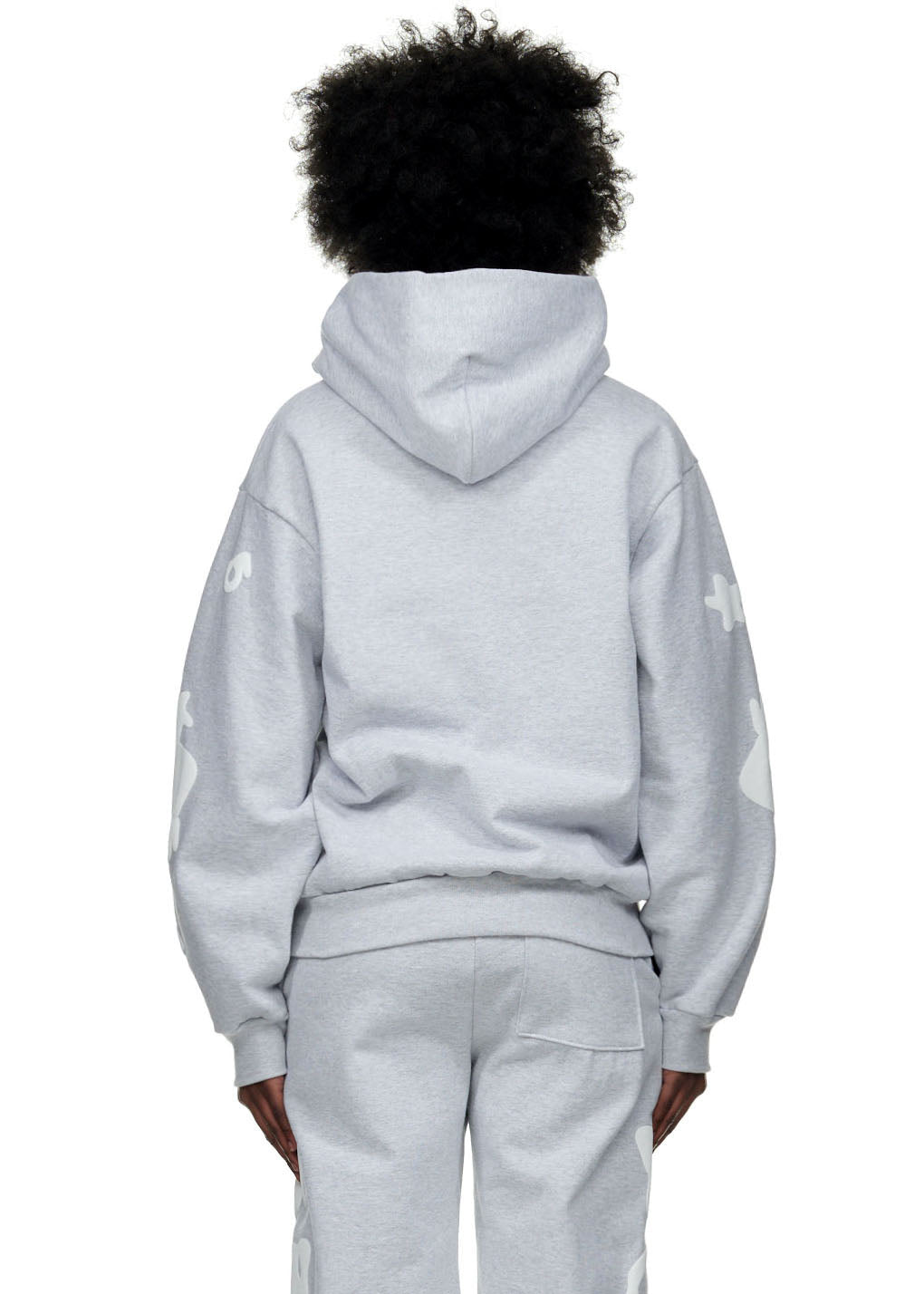 Gray 23oz fleece BELUGA HOODIE with white puff print on sleeves, worn by a person from behind.