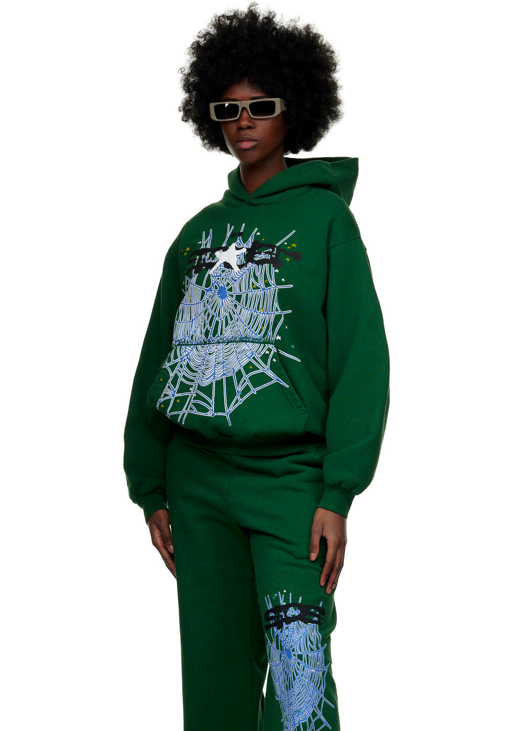 Green 23oz fleece hoodie with SP5DER text and web puff/discharge print, paired with matching sweatpants.