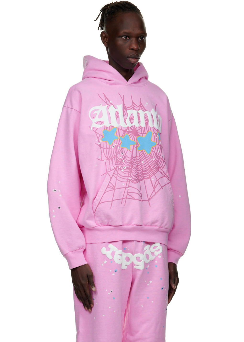 Male model in a pink Atlanta hoodie with puff print, spiderweb, and star graphics.