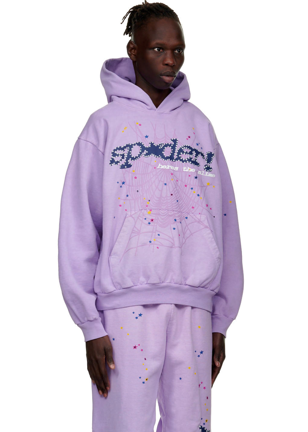 Male model in a lavender AÇAÍ SP5DER HOODIE with web, star, and "SP5DER" puff prints.