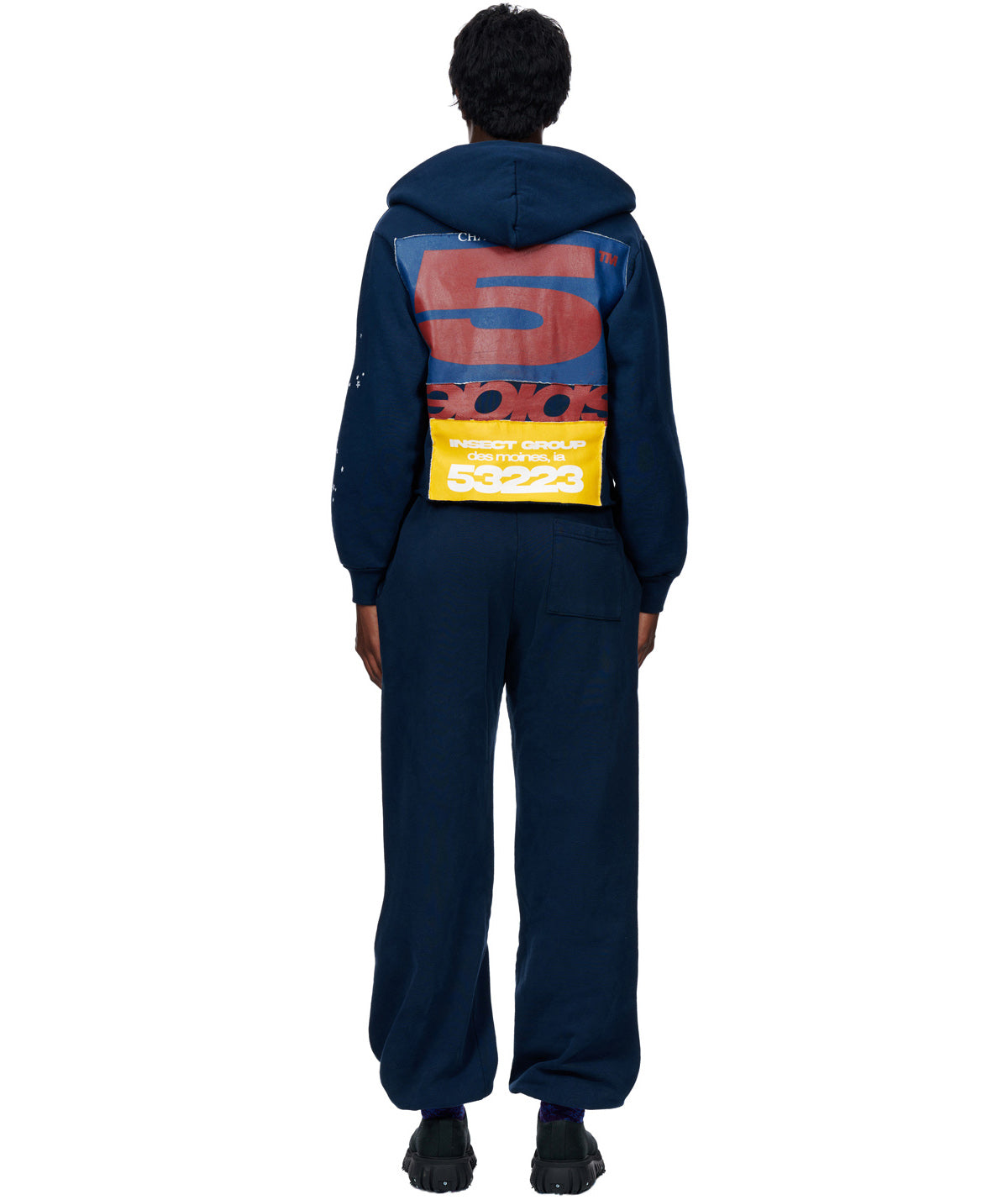 Navy cropped hoodie with large red "S" graphic, yellow "INSECT GROUP" patch, and matching sweatpants.