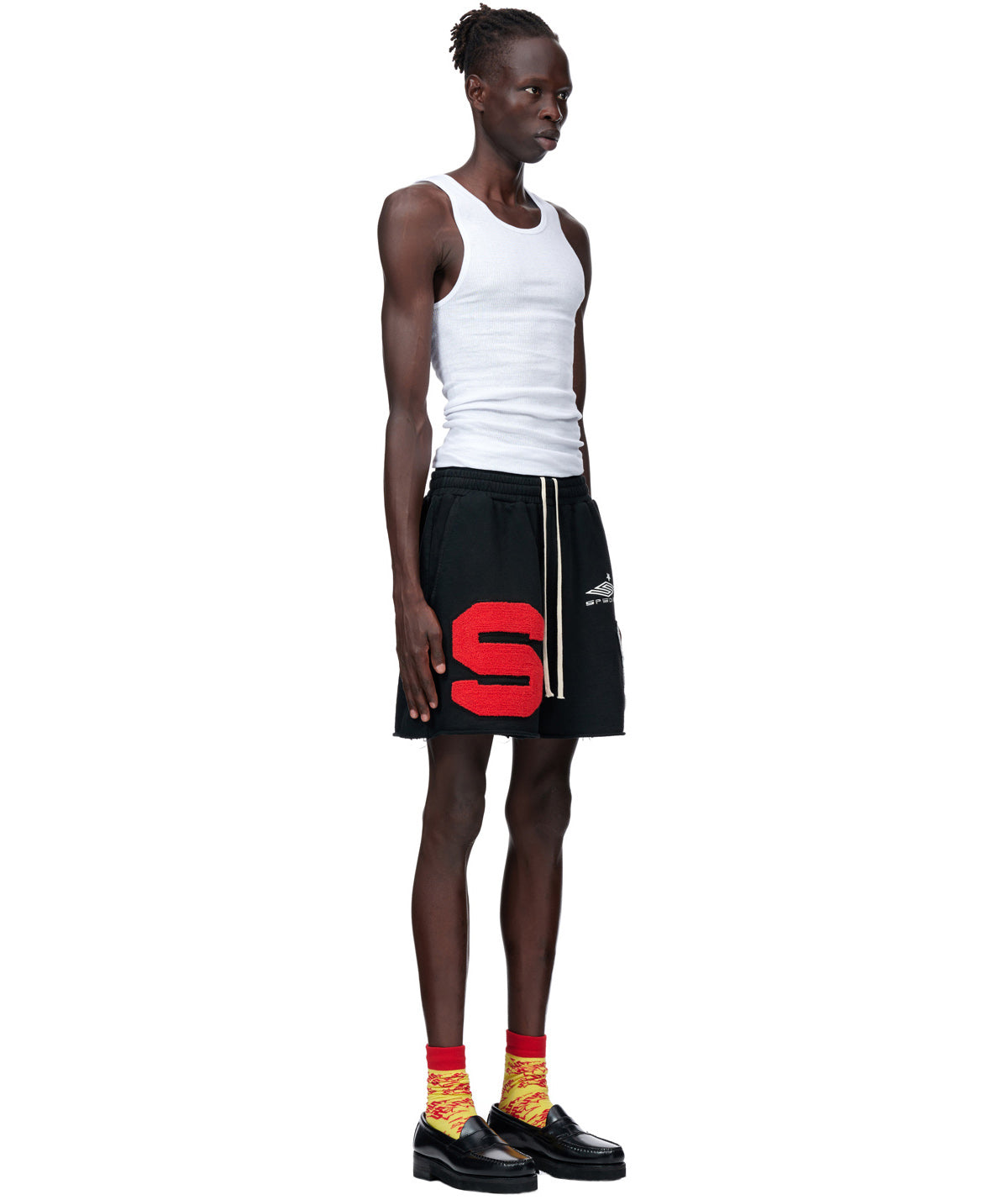 Black French terry CUT SWEATSHORT with large red chenille "S" patch, SP5DER embroidery, and raw hem.