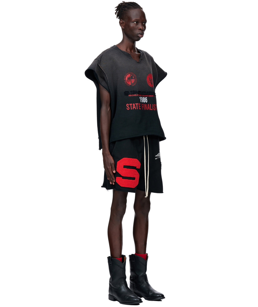Model wearing a black sun fade French terry cut sweatshirt with red SP5DER patches and "55" flock applique.