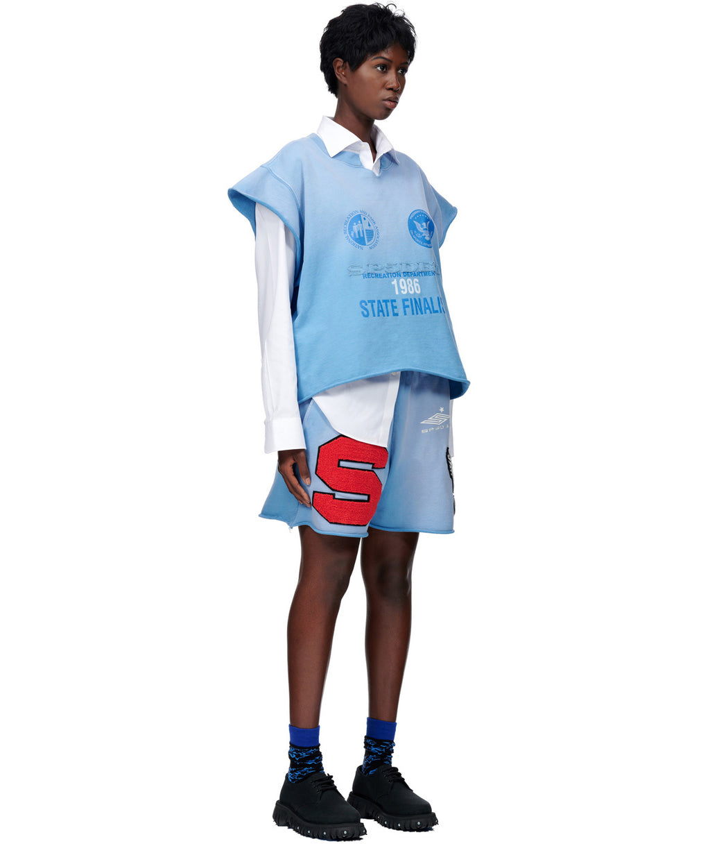 Light blue French terry cut sweatshirt and shorts with "55" flock applique, worn over a white shirt.